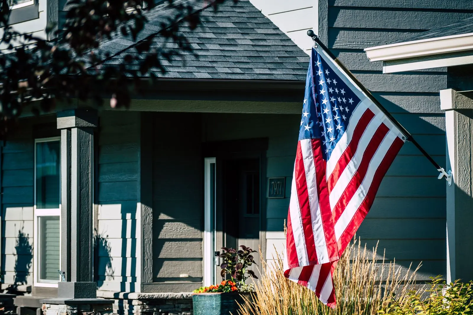 American flag on the front porch of a veteran's home, representing VA home loans for veterans and service members
